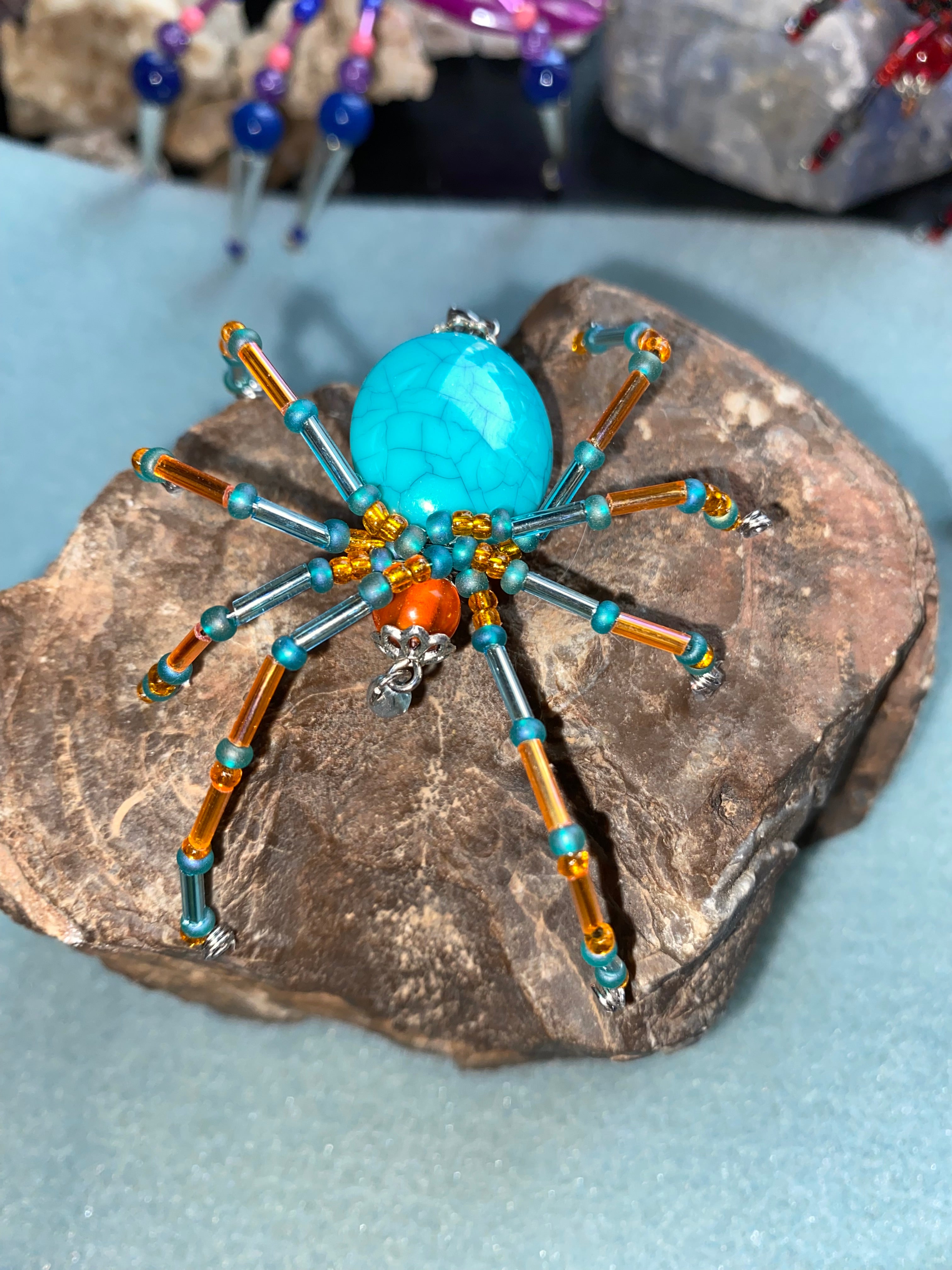 Turquoise and orange beaded spider