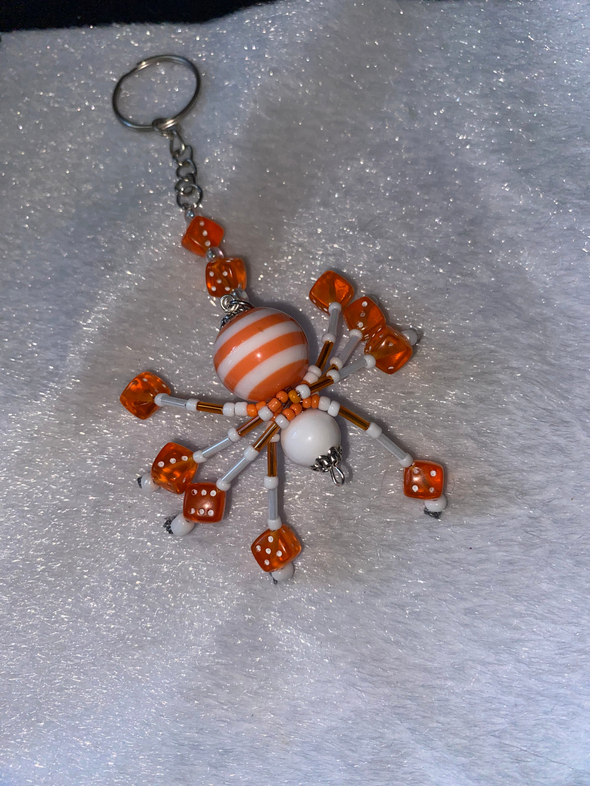 White and orange beaded spider keychain