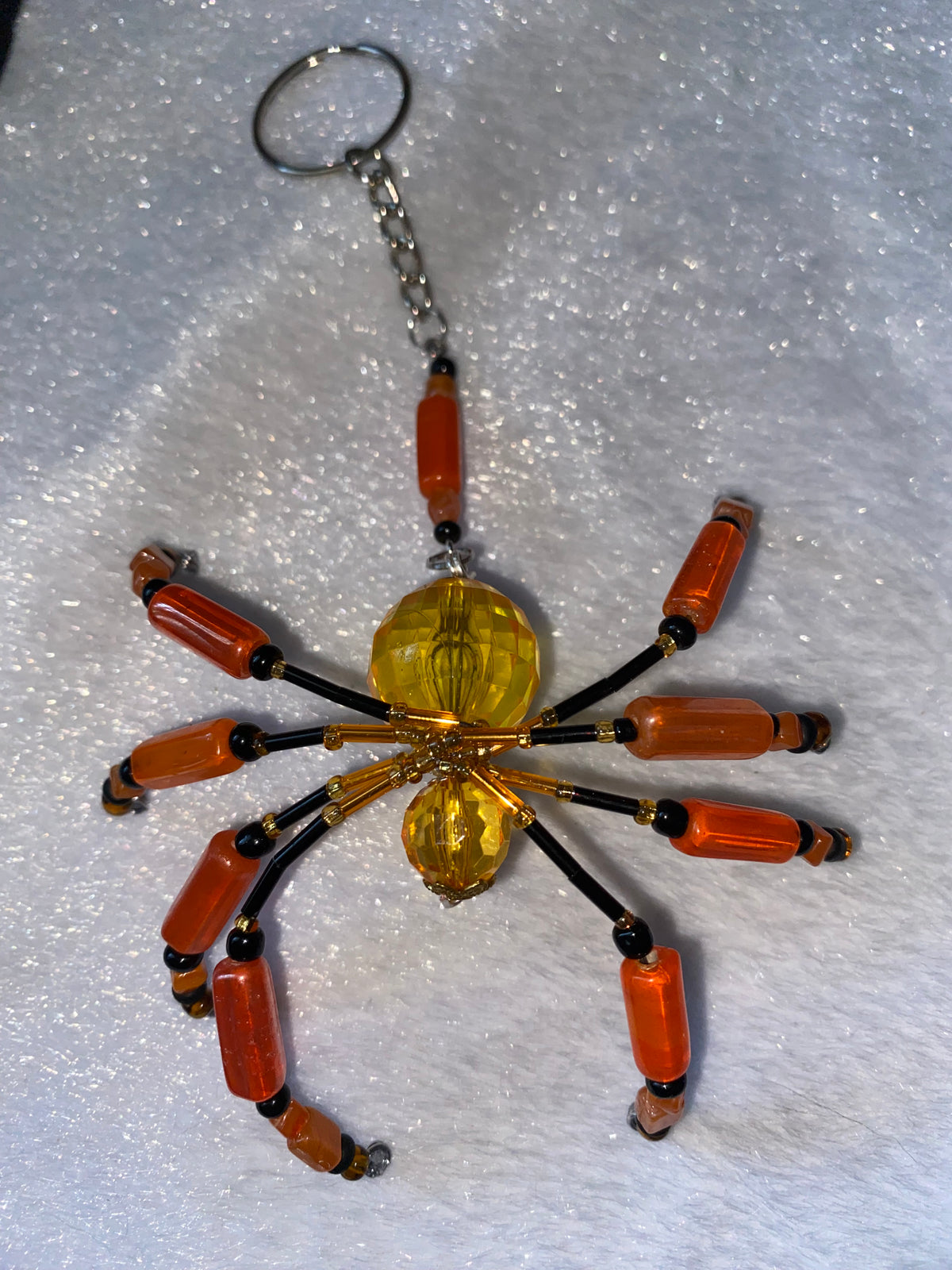 Orange and black beaded spider keychain